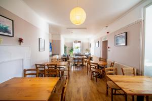 a dining room with wooden tables and chairs at Gairloch Sands Youth Hostel in Gairloch