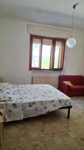 a bedroom with a bed and a window at Casa Panorama in Senigallia +3 photos