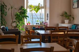 a restaurant with tables and chairs and a window at Gairloch Sands Youth Hostel in Gairloch
