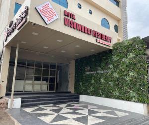 a building with a sign that reads campus university collection at Hotel Vishwaraj Residency in Solapur