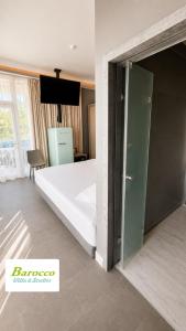 a bedroom with a bed with a glass door at Barocco Villa & Studios in Potamiá +14 photos