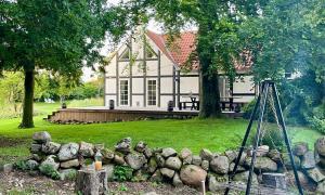 a pile of rocks in front of a house at Sjælegård Countryside Lodge in Allinge