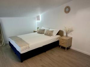 a bedroom with a large bed and a night stand at Maracas Sea View Boutiq in Costinesti