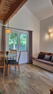 a living room with a table and a couch at Malownicza Dolina in Wapnica