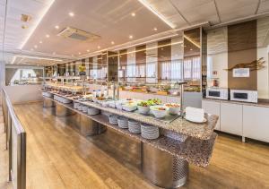 a buffet line in a restaurant with bowls of food at Hotel Alone in Cala de Finestrat