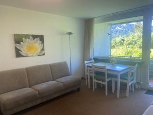 a living room with a couch and a table and a window at Alex in Balderschwang +15 photos
