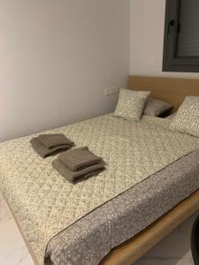a bed with two pillows on top of it at Basia in Torrevieja +26 photos