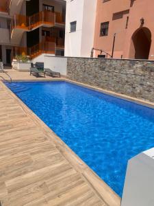 a swimming pool with blue water in a building at Basia in Torrevieja