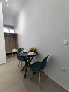 a dining room with a table and two chairs at Ioannis Fotinos Rooms in Lygia