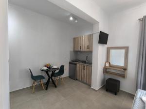 a kitchen with a table and chairs in a room at Ioannis Fotinos Rooms in Lygia
