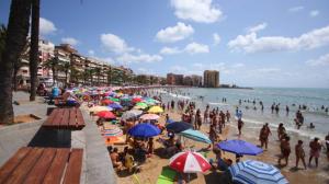 a crowd of people on a beach with umbrellas at Basia in Torrevieja