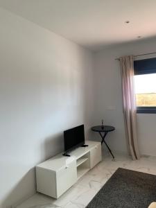 a living room with a tv on a white wall at Basia in Torrevieja