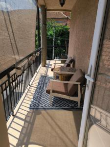 a patio with chairs and a table on a balcony at Smestaj Dzentlmen in Soko Banja