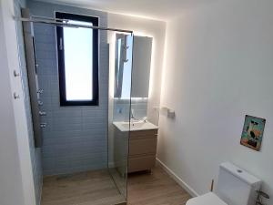 a bathroom with a glass shower and a sink at Maracas Sea View Boutiq in Costinesti +14 photos