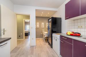 a kitchen with purple cabinets and a counter top at Bellona in Malinska