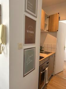 a kitchen with three pictures on the wall at Halles in Les Sables-d'Olonne