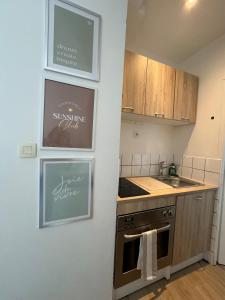a kitchen with a sink and a stove top oven at Halles in Les Sables-d'Olonne