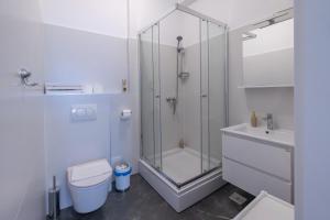 a bathroom with a shower and a toilet and a sink at Apartments Marin in Podstrana +13 photos