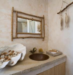 a bathroom with a sink and a mirror at Aphrodite's Oasis in Pomos +13 photos
