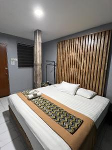 a bedroom with a large bed and a large window at TC Maya Abaya Hotel in Kuantan