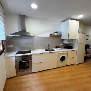 a kitchen with a sink and a stove top oven at Gre2 in El Barco de Ávila