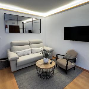 a living room with a couch and a chair at Gre2 in El Barco de Ávila