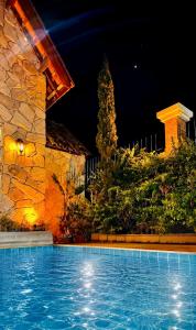 a swimming pool in front of a building at night at Chalé Jardim Itália em Tianguá in Tianguá