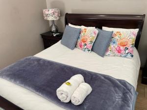 a bedroom with a bed with towels on it at Home@Harts in Hartswater