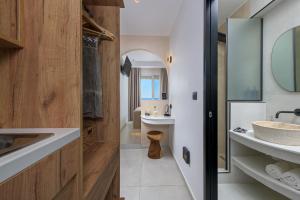 ein Badezimmer mit Waschbecken und Spiegel in der Unterkunft néreya luxury rooms in Charaki