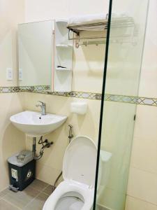 a bathroom with a toilet and a sink at MIDMOST C22 Apartment in Can Tho