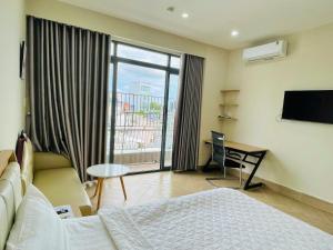 a hotel room with a bed and a large window at MIDMOST C22 Apartment in Can Tho