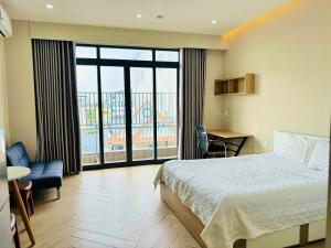a hotel room with a bed and a large window at MIDMOST C22 Apartment in Can Tho