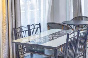 a table and chairs in front of a window at Rimayalounge in Embu