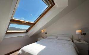a bedroom with a bed and a large window at Playa America 4F by YBH in Nigrán