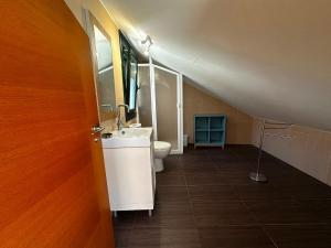 a bathroom with a sink and a toilet in a room at Playa America 4F by YBH in Nigrán