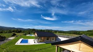 a small house with a swimming pool and a yard at Kozara Panoramic Resort in Bosanska Gradiška