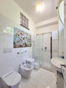 a bathroom with a toilet and a sink and a shower at Villa Blu Sorrento seaview pool terrace and Jacuzzi in Sorrento +29 photos