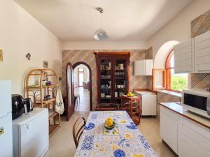 a kitchen with a table and a table and a kitchen at Villa Blu Sorrento seaview pool terrace and Jacuzzi in Sorrento