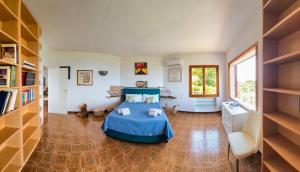 a bedroom with a bed and a book shelf at Villa Blu Sorrento seaview pool terrace and Jacuzzi in Sorrento