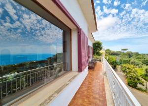 a balcony with a view of the ocean at Villa Blu Sorrento seaview pool terrace and Jacuzzi in Sorrento