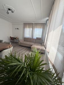 a living room with a couch and a table at Ide Vissza apartman 3 in Siófok