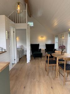 a room with a table and chairs and a bed at Velling Koller Hotel og Camping in Bryrup