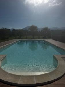 a large swimming pool with blue water at Villa Ursino in Scalea