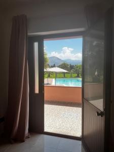 an open door with a view of a pool at Villa Ursino in Scalea