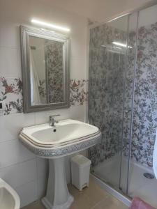 a bathroom with a sink and a shower at Villa Ursino in Scalea +5 photos
