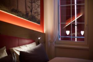 a bedroom with a window with two hearts on it at La Filanda Relax&Gourmet in Denno
