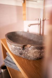 a stone sink on a wooden counter in a bathroom at La Filanda Relax&Gourmet in Denno +156 photos