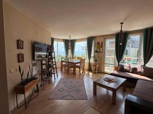 a living room with a couch and a table at Europe Holiday Apartments First Sea Line Coast in Pomorie