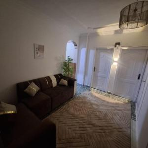a living room with a couch and a white door at الشرقيه in Kafr al Ishārah