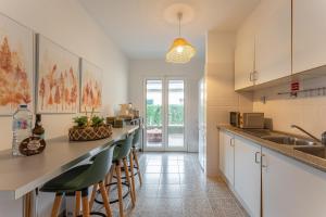 a kitchen with a counter and stools in a room at Cozy Haven Santana - Nature & Hiking Trails in Santana